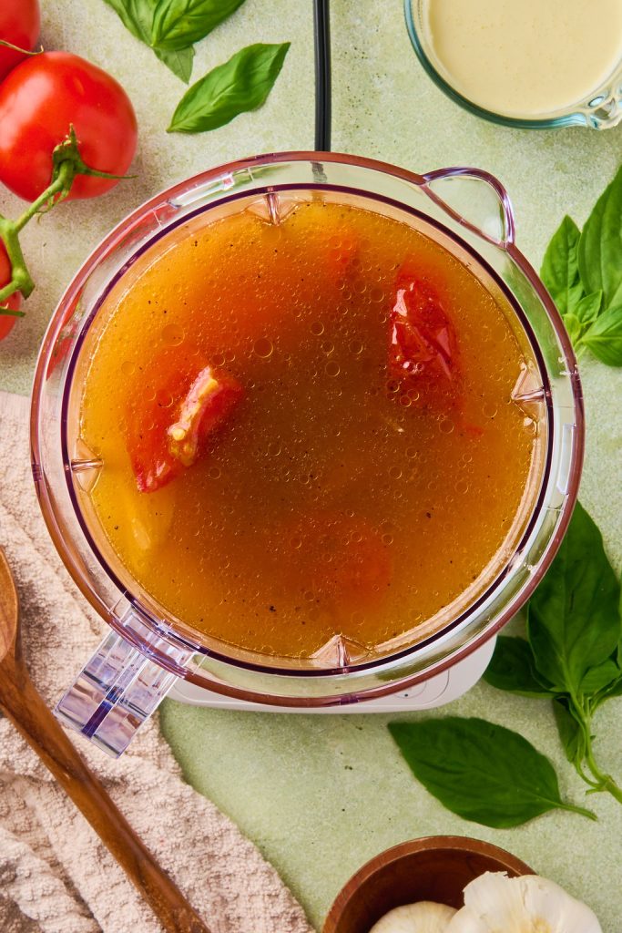 broth added to the roasted veggies in a blender