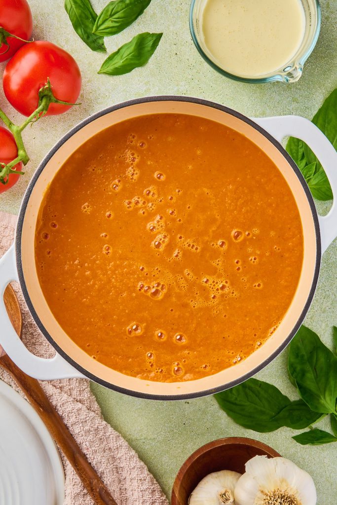 blended veggies and broth mixture added to a pot