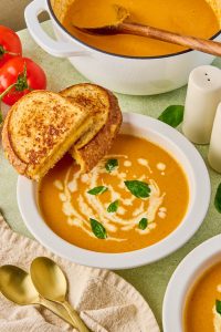 creamy roasted carrot tomato soup in a bowl