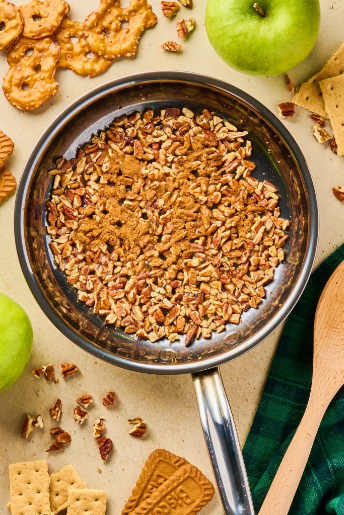maple syrup and cinnamon added tot he toasted pecans in a skillet