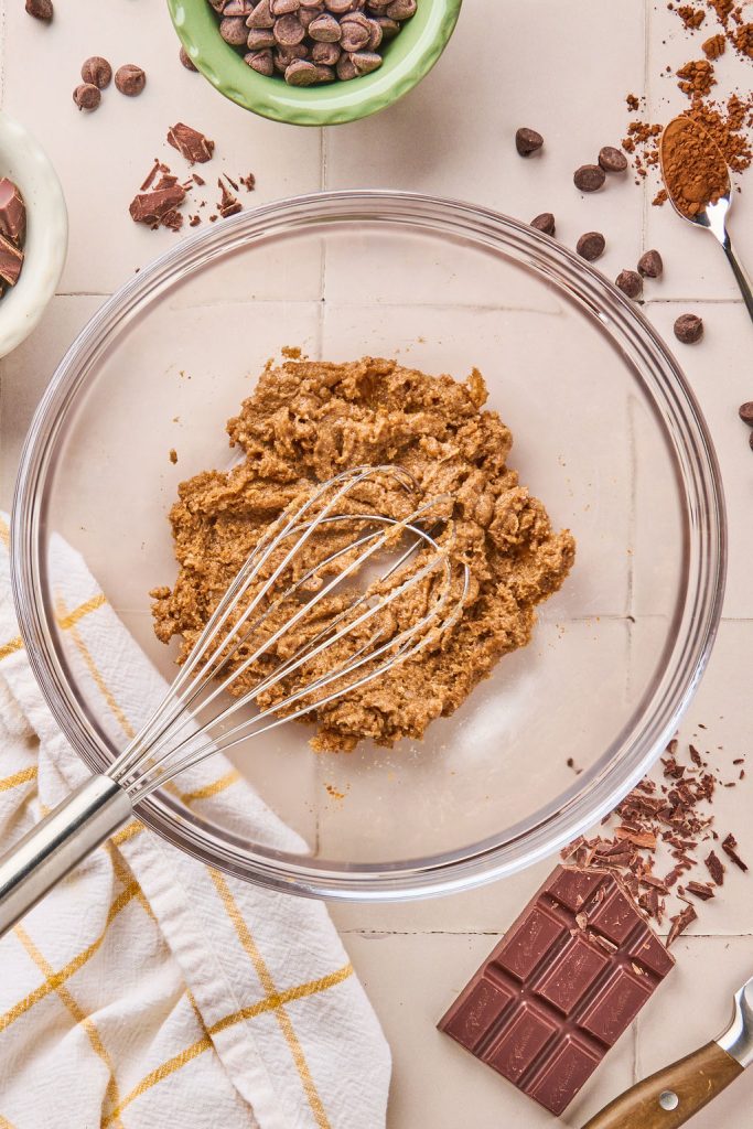 coconut oil and sugar whisked together in a glass bowl