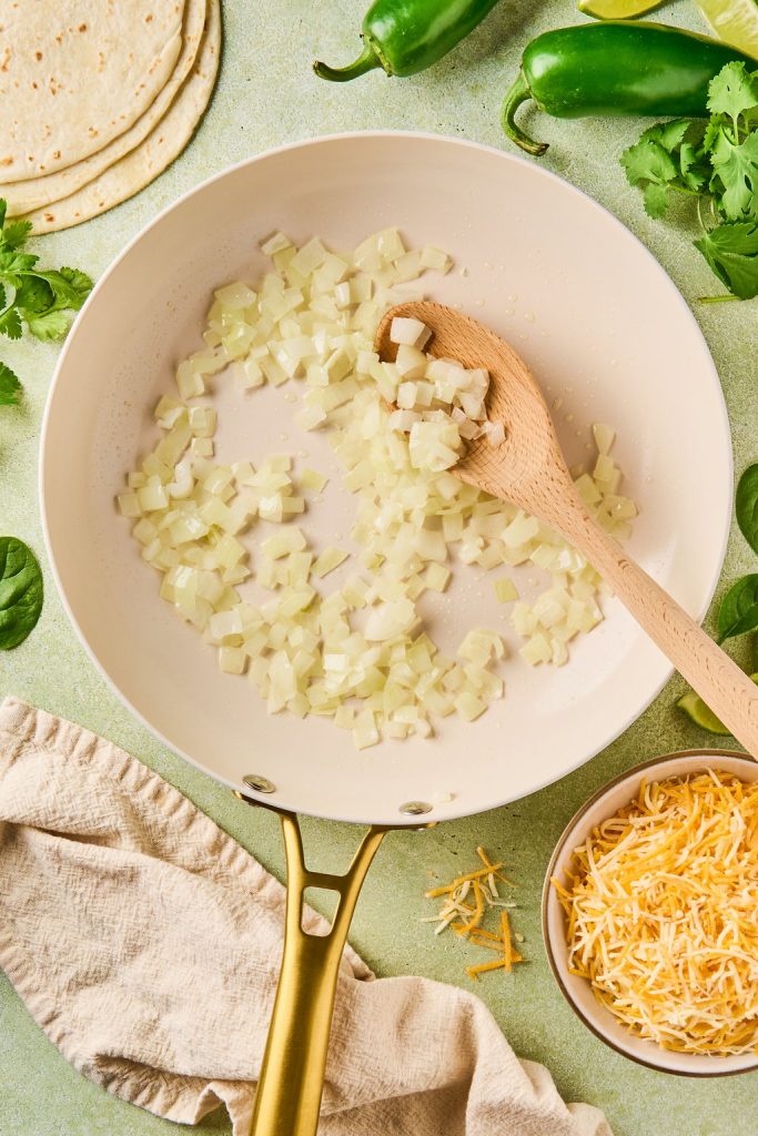 diced onion being browned in a skillet
