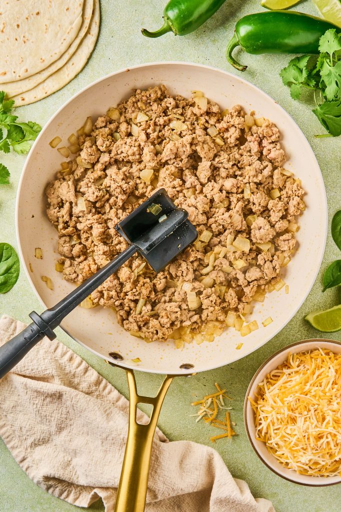 cooked ground turkey and onions in a skillet