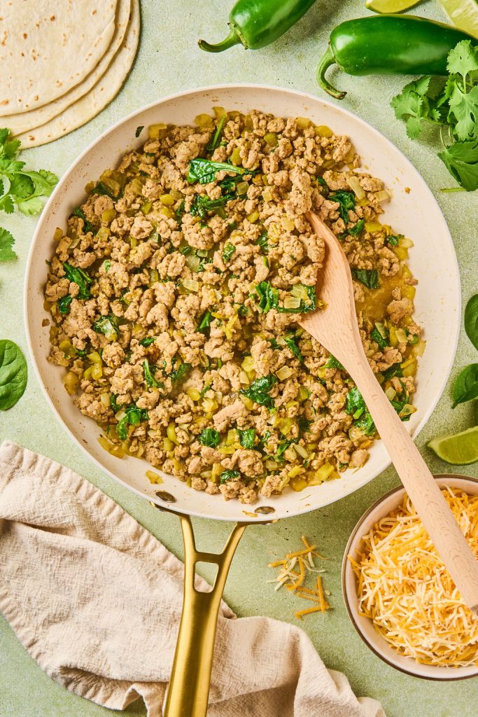 enchilada sauce and spinach mixed into ground turkey and cooked down